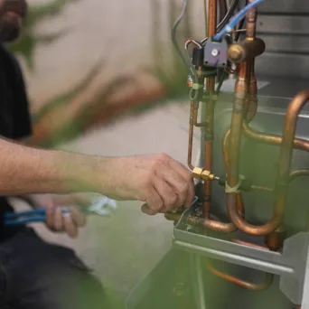 Close-up of copper gas pipework being connected
